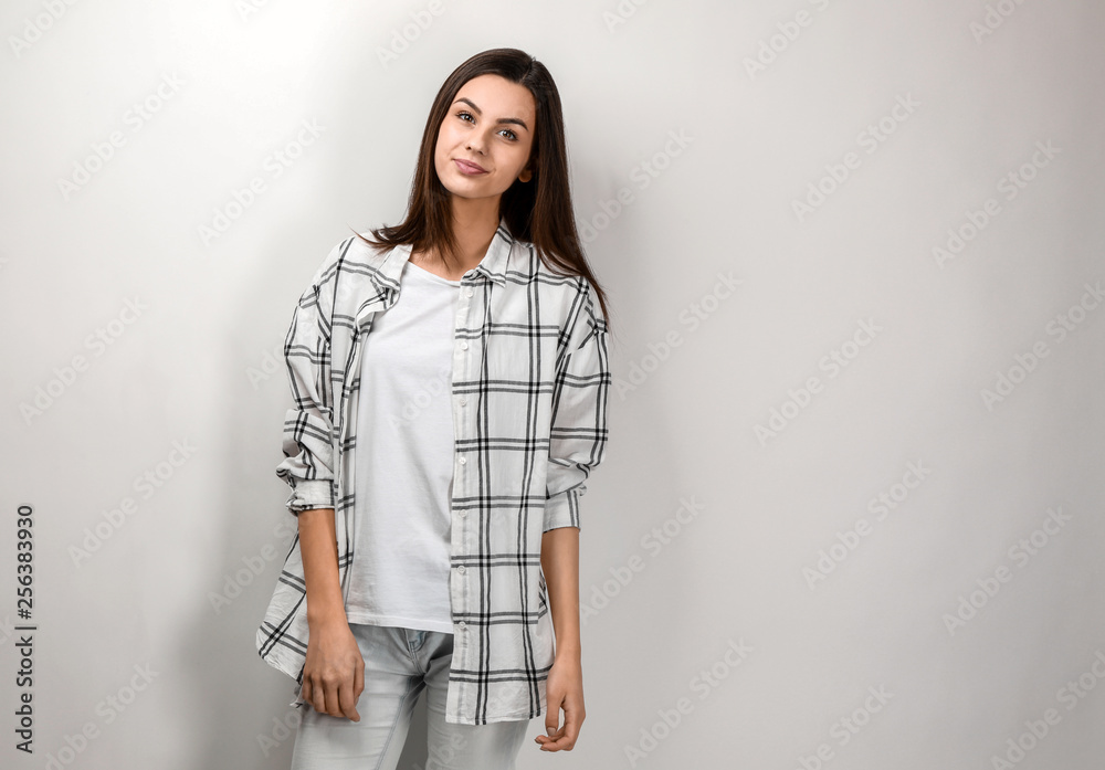 Portrait of beautiful woman in casual clothes on light background Portrait of beautiful woman in casual clothes on light background
