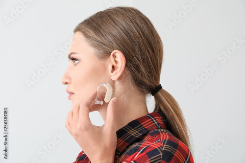 Young woman with hearing ai...
