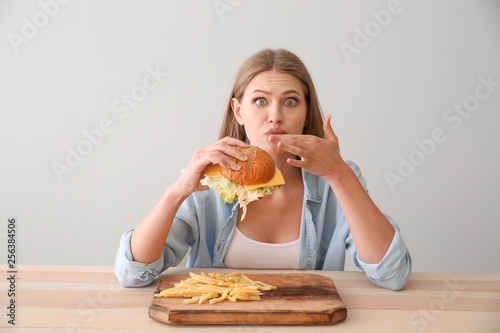 Funny woman eating tasty bu...