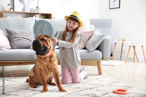 Cute little girl playing wi...