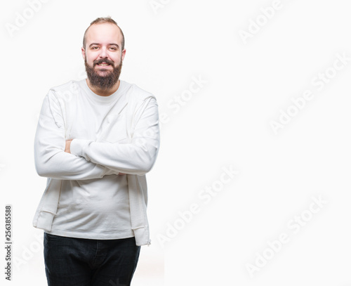 Young caucasian hipster man wearing sport clothes over isolated background happy face smiling with crossed arms looking at the camera. Positive person. © Krakenimages.com