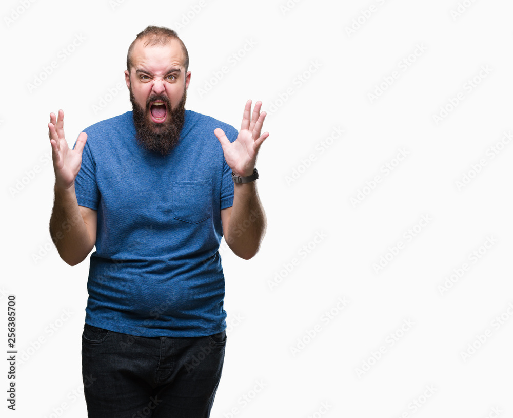 Young caucasian hipster man over isolated background crazy and mad shouting and yelling with aggressive expression and arms raised. Frustration concept. Young caucasian hipster man over isolated background crazy and mad shouting and yelling with aggressive expression and arms raised. Frustration concept.
