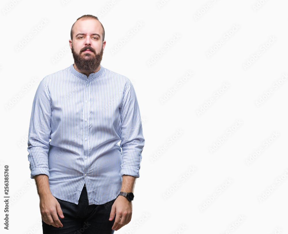 Young caucasian hipster man over isolated background with serious expression on face. Simple and natural looking at the camera. Young caucasian hipster man over isolated background with serious expression on face. Simple and natural looking at the camera.