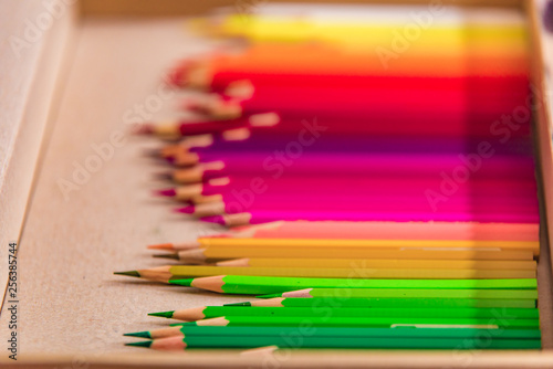 Color pencils with soft selective focus on craft background. Close up, defocused background, drawing, education frame concept with copy space. Design concept - Top view