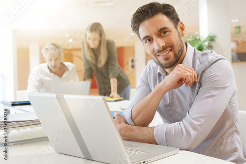 Startup team member working on computer in office