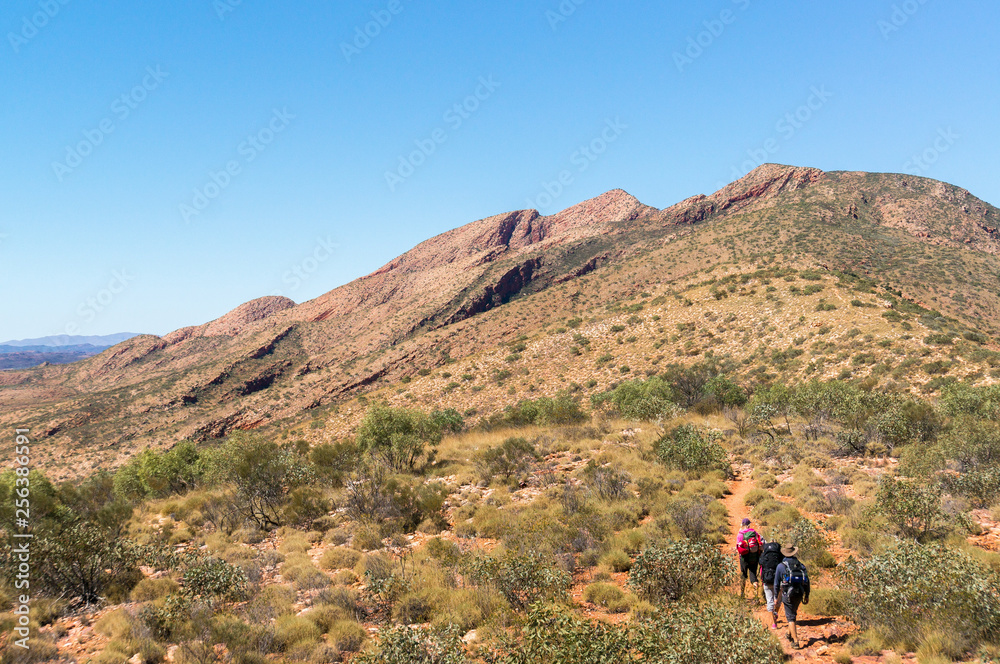 Hikers on the way to the top of Mount Sonder just outside Alice Springs, West MacDonnel National Park, Australia