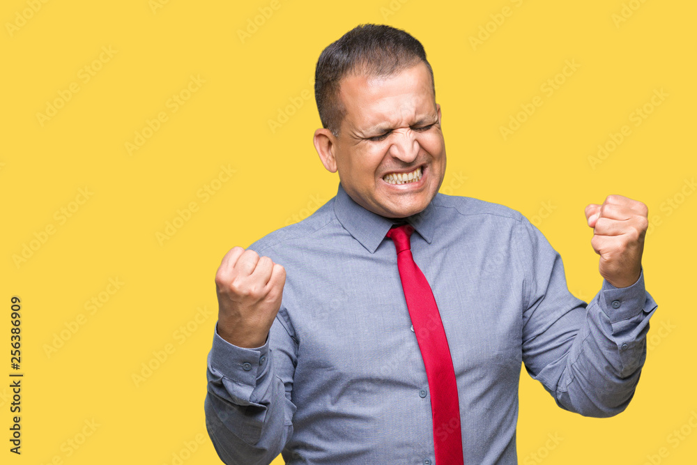 Middle age arab man wearing red tie over isolated background very happy and excited doing winner gesture with arms raised, smiling and screaming for success. Celebration concept. Middle age arab man wearing red tie over isolated background very happy and excited doing winner gesture with arms raised, smiling and screaming for success. Celebration concept.