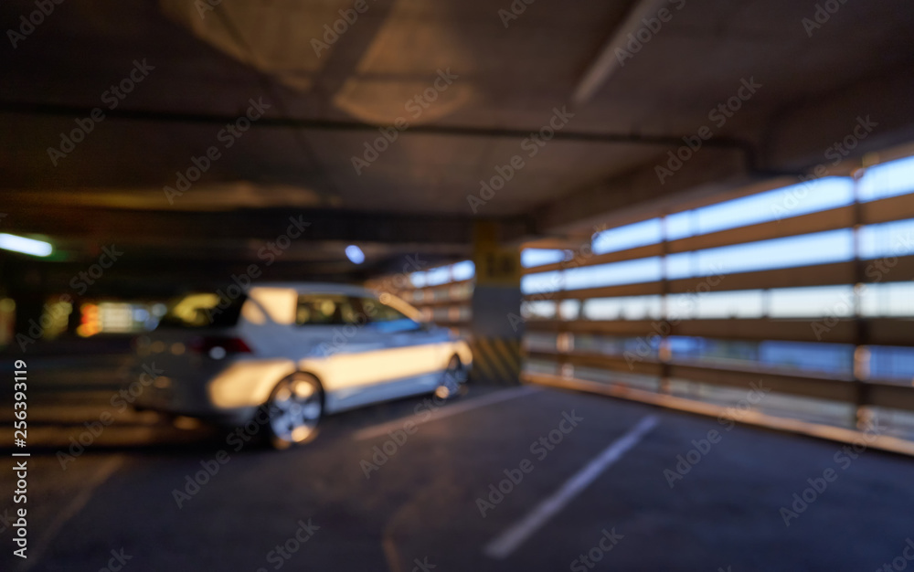 Defocused image and blurred background, car and sun rays on a special parking in the mall. Defocused image and blurred background, car and sun rays on a special parking in the mall.