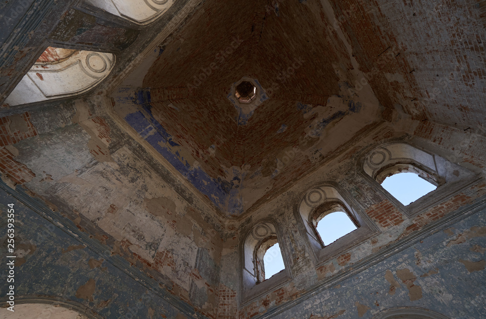 Ceiling with windows in a tall tower inside an abandoned church