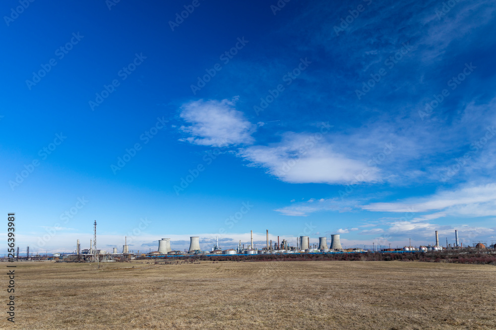 Oil refinery with facilities, tanks and trains