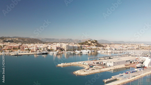 Aerial view of Denia port. The city and the Denia castle in the background.