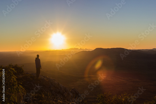 man enjoying sunset after a hike to the top of Mount Sonder just outside Alice Springs  West MacDonnel National Park  Australia