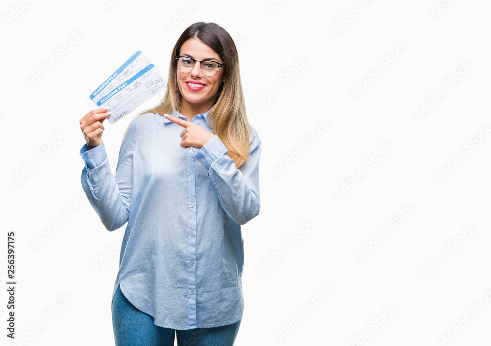 Young beautiful woman holding boarding pass over isolated background very happy pointing with hand and finger Young beautiful woman holding boarding pass over isolated background very happy pointing with hand and finger