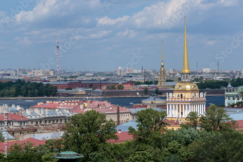 Admiralty spire and Peter and Paul fortress, view of the Neva river and residential buildings of St. Petersburg from a height.