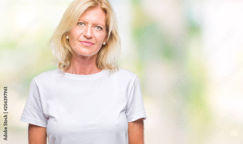Obraz premium Middle age blonde woman over isolated background with serious expression on face. Simple and natural looking at the camera.