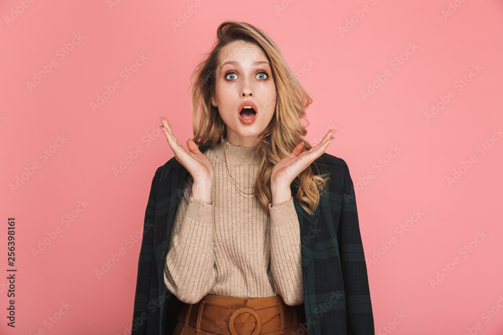 Portrait of surprised blond woman 30s in stylish outfit expressing astonishment on camera Portrait of surprised blond woman 30s in stylish outfit expressing astonishment on camera