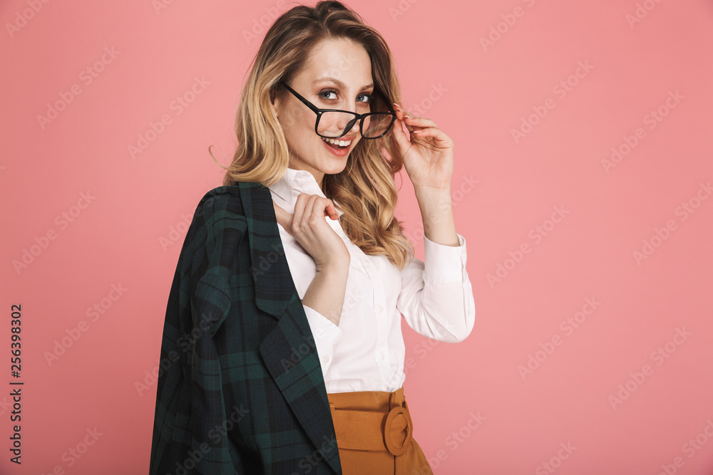 Portrait of gorgeous blond woman 30s in stylish outfit touching eyeglasses and looking on camera Portrait of gorgeous blond woman 30s in stylish outfit touching eyeglasses and looking on camera
