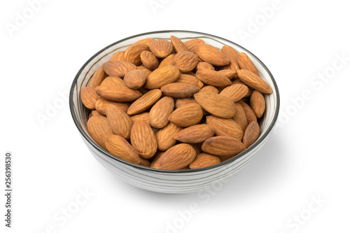 Bowl with peeled almonds close up