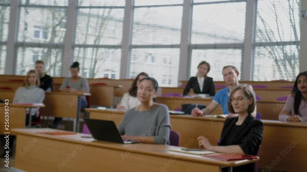 Lecturer and multinational group of students in an auditorium Lecturer and multinational group of students in an auditorium