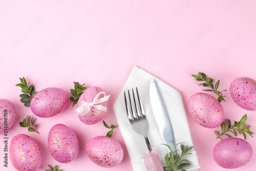 Easter. Pink Easter eggs and plate, knife and fork on a trendy pink background. Easter table setting. Happy easter. holidays. top view