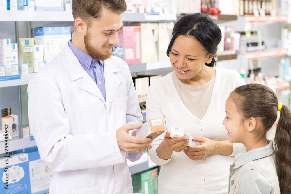 Professional pharmacist helping his customers Professional pharmacist helping his customers