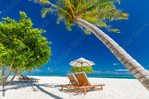 Luxury beach resort, beach loungers near the sea with white sand over sea Topical island background, summer vacation concept, holiday and tourism design. Exotic landscape, inspirational leisure banner