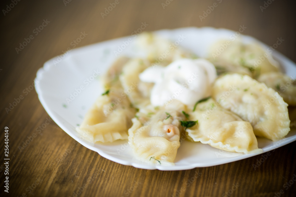 Dumplings boiled with stuffing on a wooden table Dumplings boiled with stuffing on a wooden table