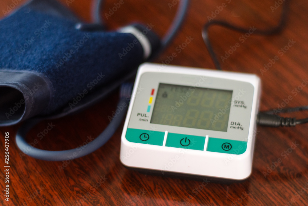 medical tonometer on red wooden background medical tonometer on red wooden background