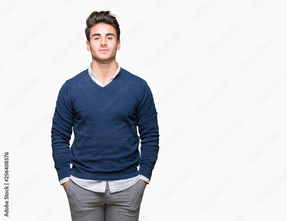 Young handsome business man over isolated background with serious expression on face. Simple and natural looking at the camera.