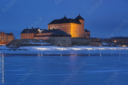 Hameenlinna, Finland. Hame Castle or Tavastia Castle in winter dusk. The castle was constructed in the 13th century. photo