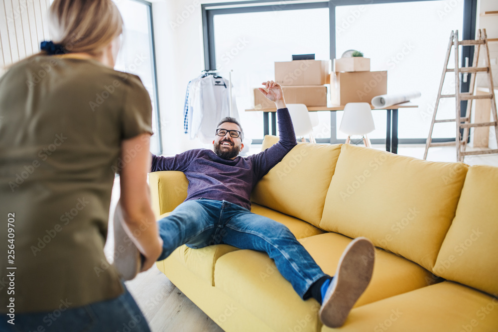 A young couple moving in new home, having fun. A young couple moving in new home, having fun.