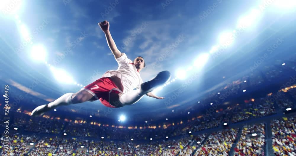 Soccer player succeed in making a strong kick with his feet while jumping horizontally. The player is wearing unbranded soccer uniform. The stadium and crowd are made in 3D and animated.