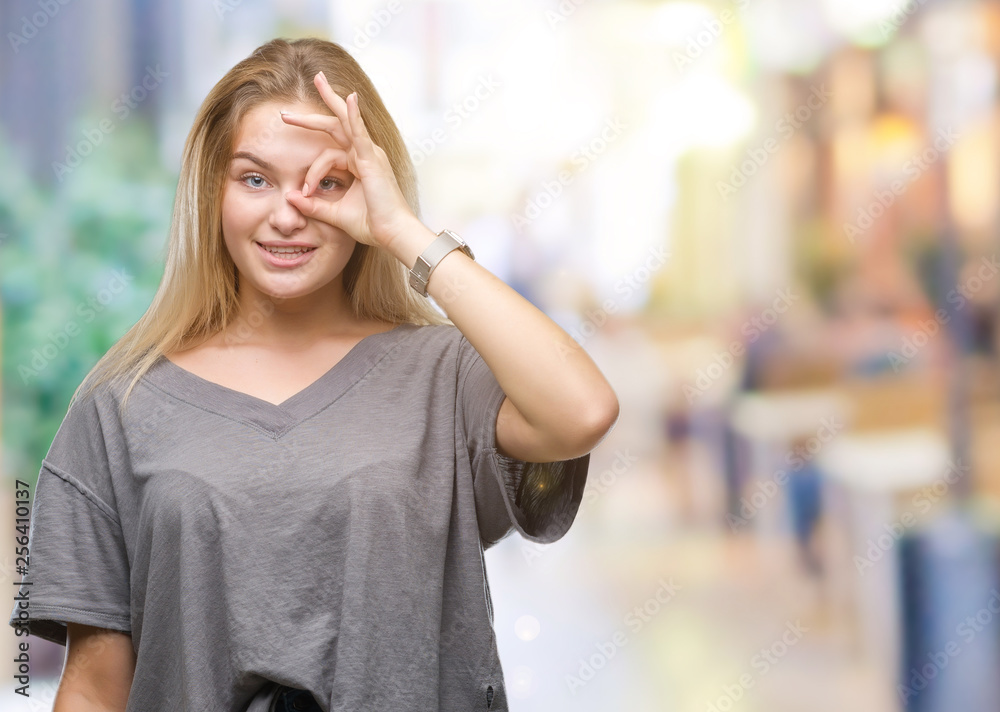 Young caucasian woman over isolated background doing ok gesture with hand smiling, eye looking through fingers with happy face. Young caucasian woman over isolated background doing ok gesture with hand smiling, eye looking through fingers with happy face.