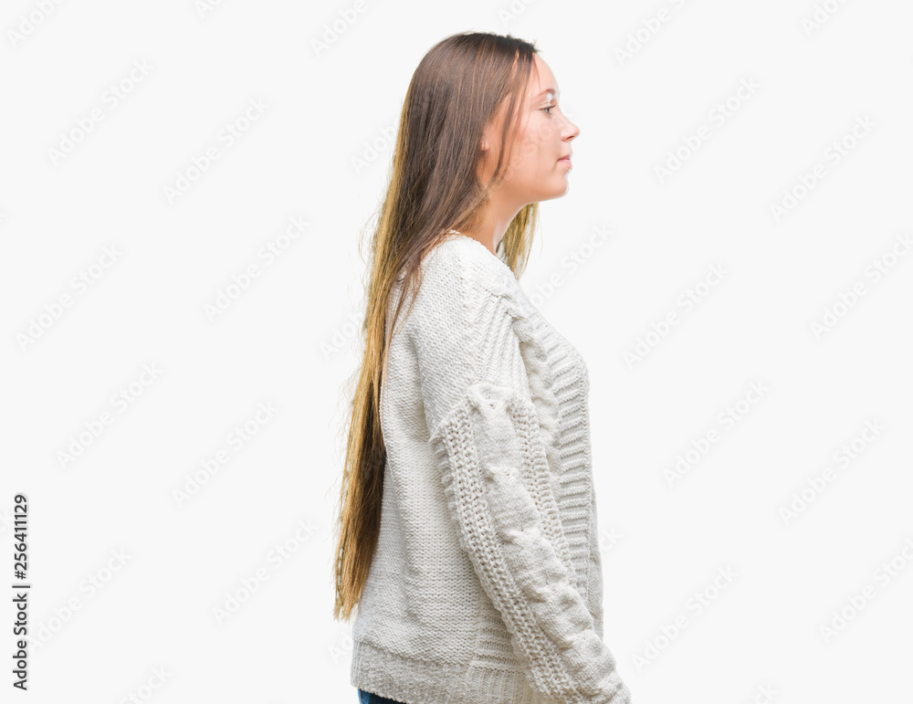 Young beautiful caucasian woman wearing winter sweater over isolated background looking to side, relax profile pose with natural face with confident smile.