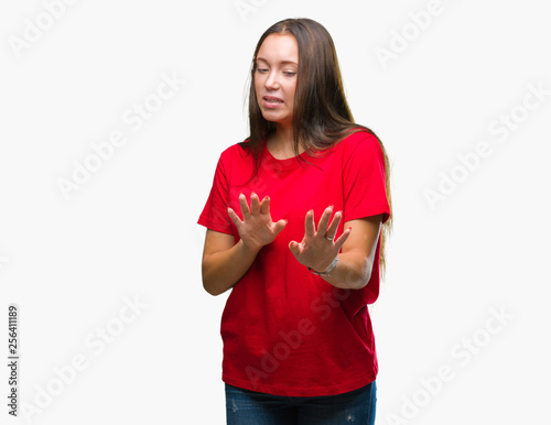 Young beautiful caucasian woman over isolated background disgusted expression, displeased and fearful doing disgust face because aversion reaction. With hands raised. Annoying concept.