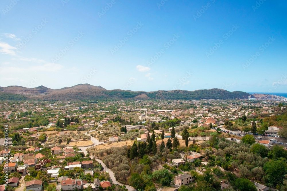 Top view from the ancient fortress on the Old Bar in Montenegro. Landscape with mountains and sky. Houses with red roofs.