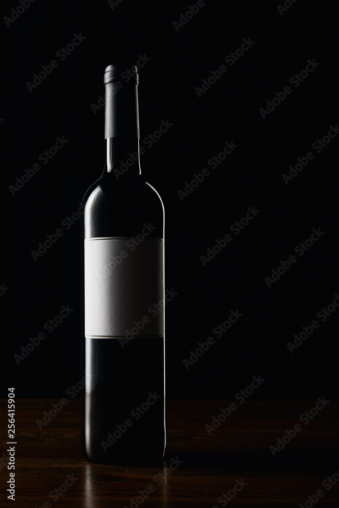 Wine bottle with blank label on wooden surface Wine bottle with blank label on wooden surface