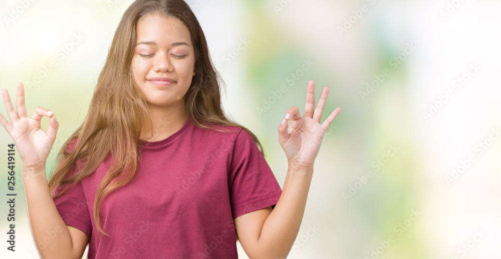 Young beautiful brunette woman over isolated background relax and smiling with eyes closed doing meditation gesture with fingers. Yoga concept. Young beautiful brunette woman over isolated background relax and smiling with eyes closed doing meditation gesture with fingers. Yoga concept.