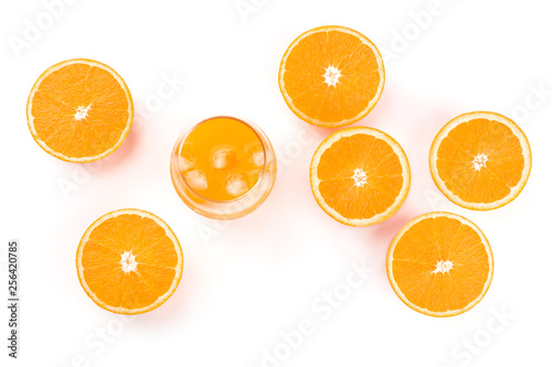 A glass of fresh orange juice with orange halves  shot from the top on a white background with a place for text