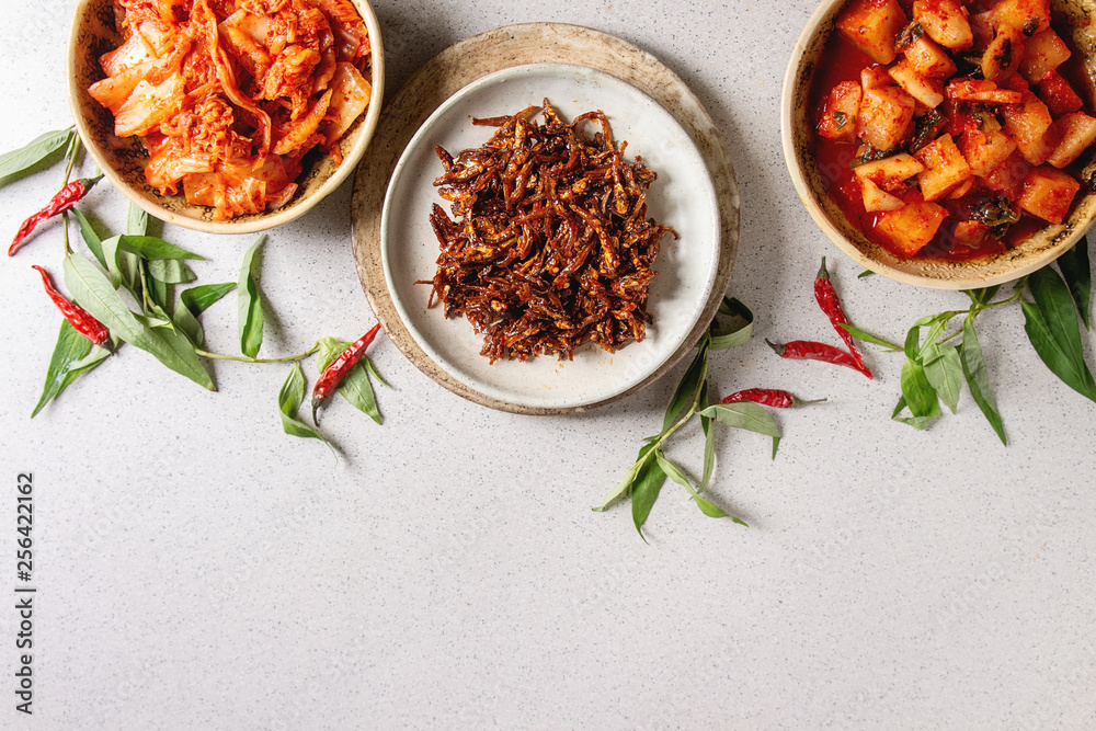 Korean traditional fermented appetizer kimchi cabbage and radish salad, hot spicy anchovies fish