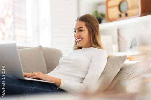 Young woman using her laptop at home 