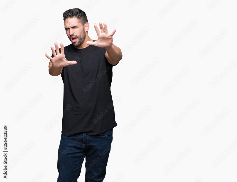 Young handsome man over isolated background afraid and terrified with fear expression stop gesture with hands, shouting in shock. Panic concept. Young handsome man over isolated background afraid and terrified with fear expression stop gesture with hands, shouting in shock. Panic concept.