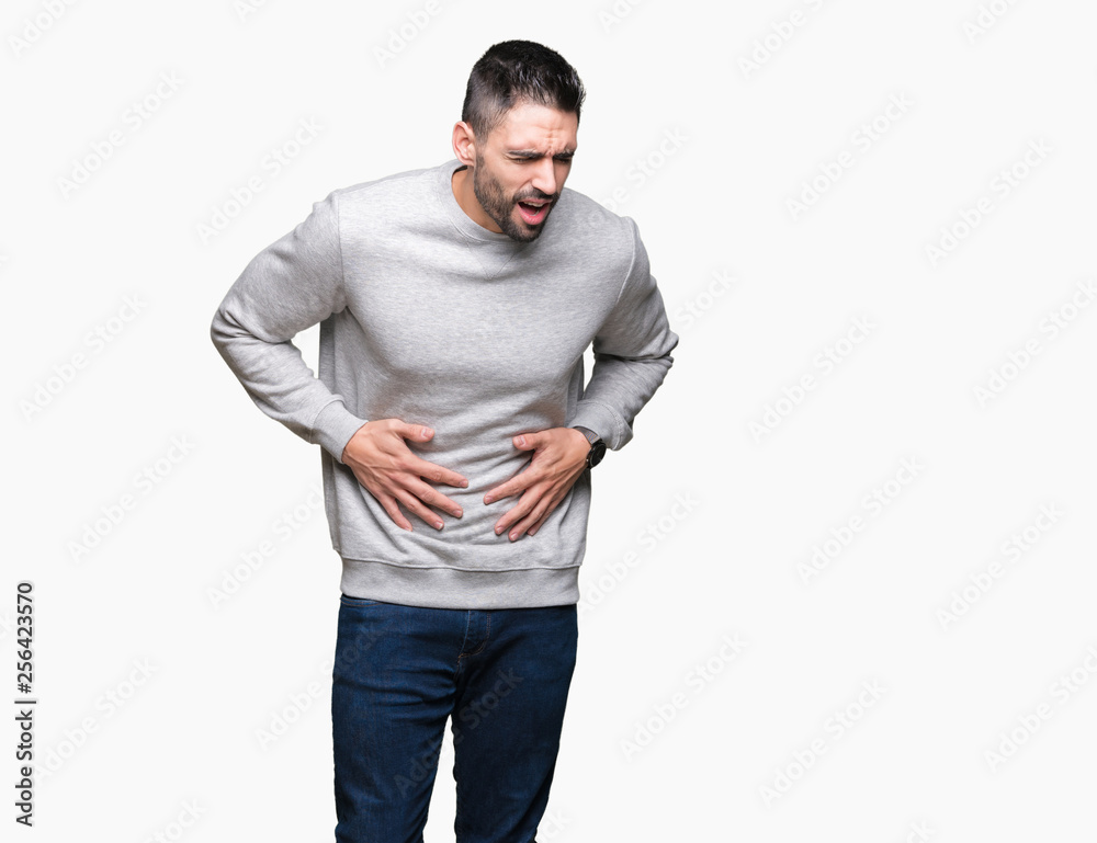 Young handsome man wearing sweatshirt over isolated background with hand on stomach because indigestion, painful illness feeling unwell. Ache concept. Young handsome man wearing sweatshirt over isolated background with hand on stomach because indigestion, painful illness feeling unwell. Ache concept.
