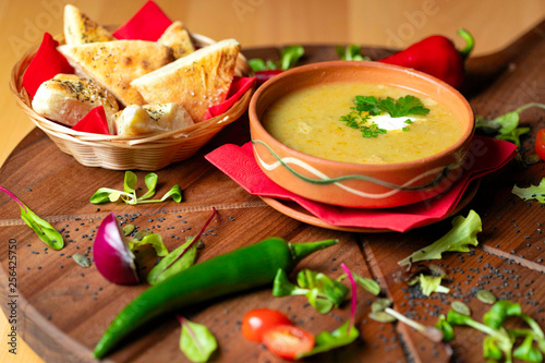 Cream soup in ceramic bowl on wooden table