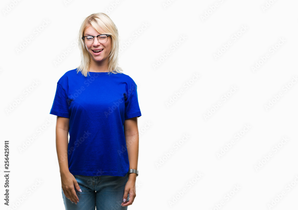 Fototapeta premium Young beautiful blonde woman wearing glasses over isolated background winking looking at the camera with sexy expression, cheerful and happy face.
