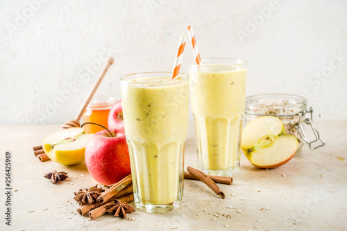 Healthy breakfast, snack. Spicy  smoothie with apple, honey, oatmeal, cinnamon, anise. Light concrete background copy space