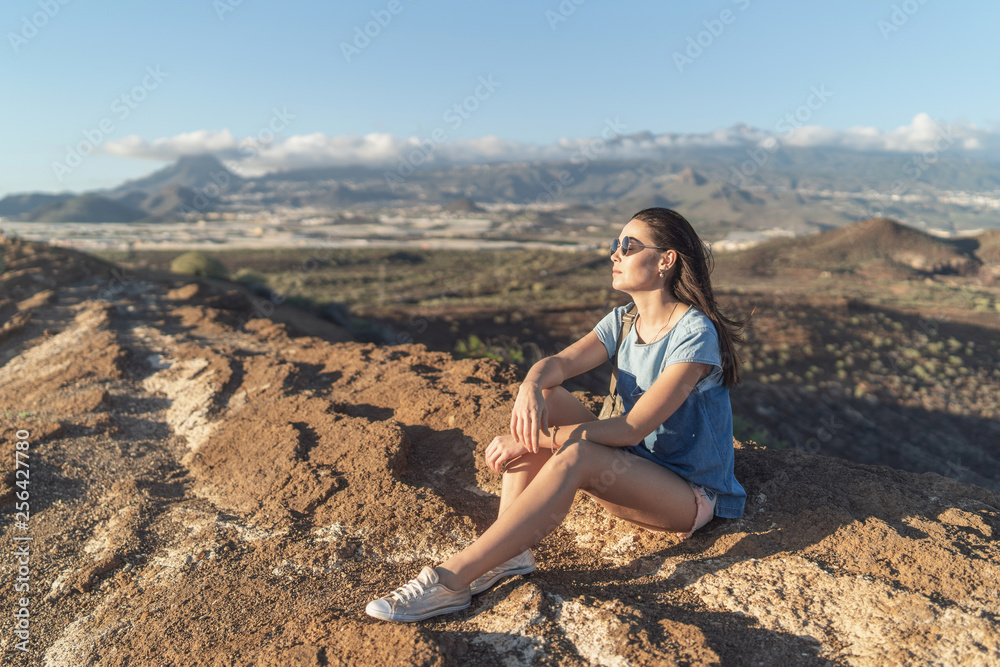 Pretty tourist brunette girl relaxing near mountains. Pretty tourist brunette girl relaxing near mountains.