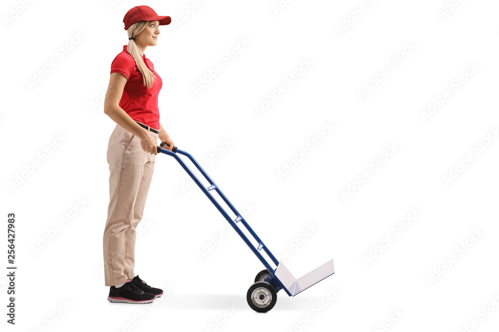Female worker standing with an empty hand truck Female worker standing with an empty hand truck