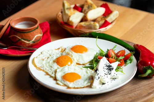 Fried eggs with cheese and tomatoes, breakfast