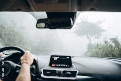 Man driving car with view from inside.
